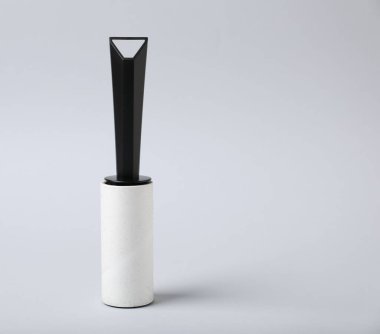 One lint roller on light grey background, space for text