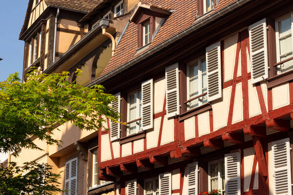 Colmar. France. May 22, 2023. Beautiful French city in Alsace. Colorful wooden building facades with windows. Traditional old architecture. Sunny summer day.