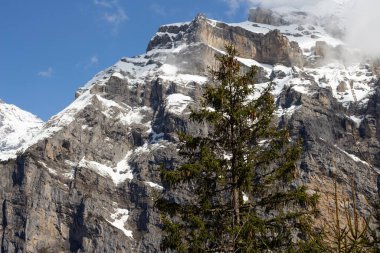 İsviçre 'deki dağlarda. Mavi gökyüzüne karşı karlı bir tepe. Turist beldesi. Avrupa 'da Doğa