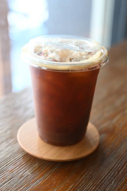 coffee ice in plastic glass on table wood
