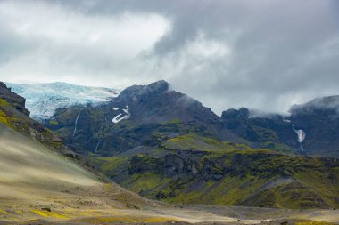 Svartifoss waterfall in Skaftafell Vatnajokull National Park, Iceland with green dramatic landscape