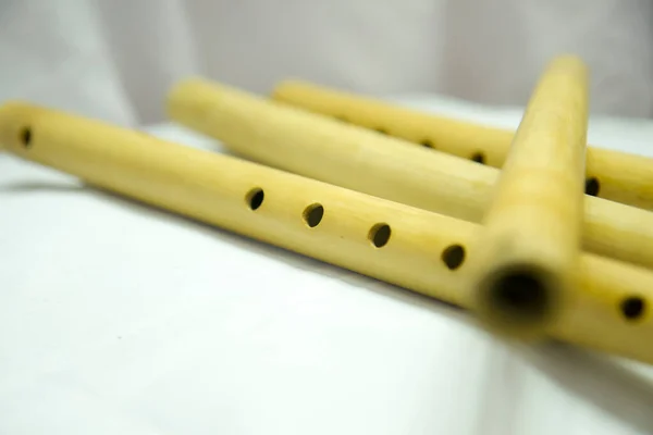 stock image A flute with holes in it is laying on a white cloth Nepali Bamboo Flute Basuri
