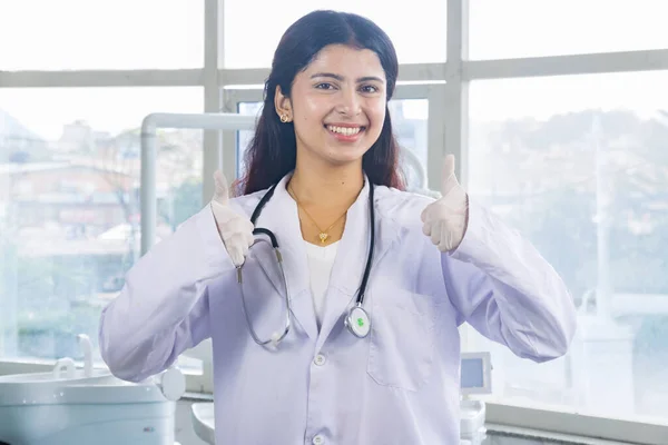 Beautiful Indian Looking Nepali Dentist Doctor Girl Smiling and Giving gestures