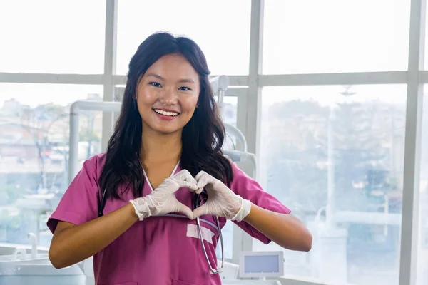 Confident Beautiful Indian Looking Nepali Dentist Doctor Girl Smiling and Giving gestures