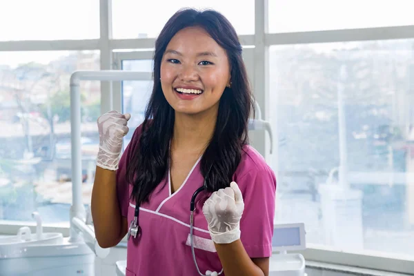 Confident Beautiful Indian Looking Nepali Dentist Doctor Girl Smiling and Giving gestures