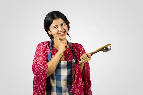 Beautiful Nepalese Indian Housewife in Kurthi, Apron with Kitchen Utensils Smiling, Giving Gestures