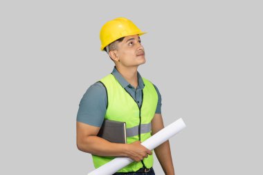 Asyalı Mutlu İnşaat Mühendisi, karton kağıt ve defterle ifade jestleri yapıyor.