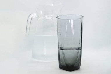 bir cam sürahi ve yanında cam bir bardak soğuk su dökülüyor izole edilmiş beyaz arka plan png