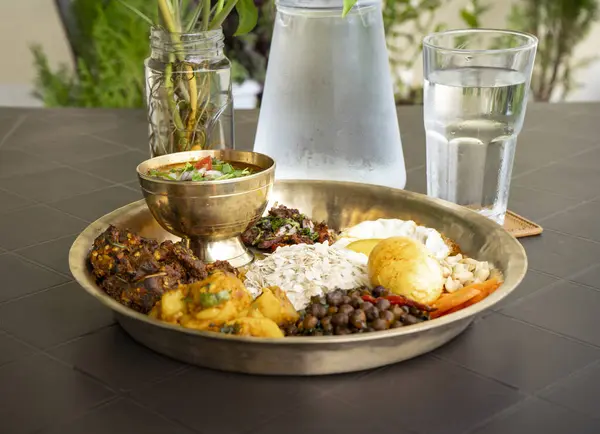 stock image Newari Khaja Set Typical Nepali Thali with Rice Flakes, Choyila, Eggs, Chickpeas, Tama, Bamboo Soup, Aalu Sadheko Lunch