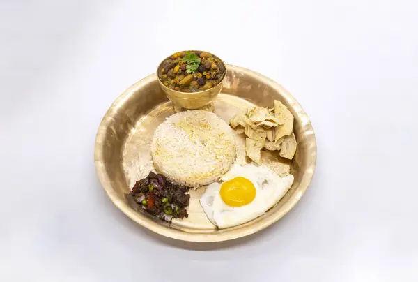 stock image Nepali Thali Set with Kwati Mix Bean Soup, Rice, Omlette in a plate for Janai Purnima or Gunhi Punhi