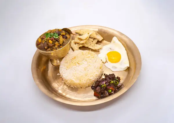 stock image Nepali Thali Set with Kwati Mix Bean Soup, Rice, Omlette in a plate for Janai Purnima or Gunhi Punhi