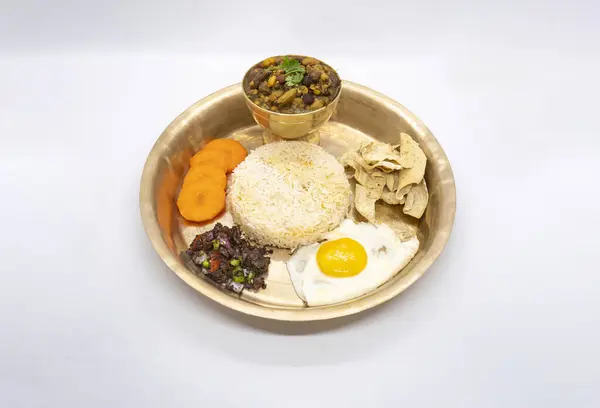 stock image Nepali Thali Set with Kwati Mix Bean Soup, Rice, Omlette in a plate for Janai Purnima or Gunhi Punhi