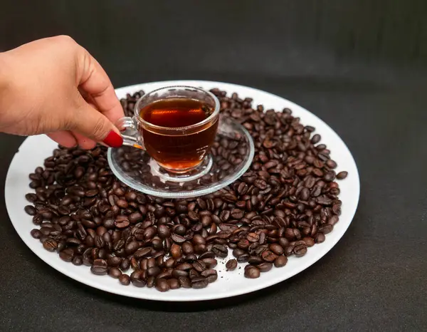 stock image Espresso Americano in a glass cup with fresh coffee beans scattered around Isolated White Background