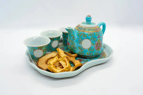 stock image Dehydrated Dried Apple Fruit with Tea pouring served in the afternoon dry fruit snack with green tea