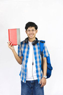 Çanta, Kitap ve kulaklıkla Yurtdışında Genç Erkek Çalışması İfade ve jestler sunar