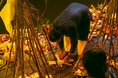 Kathmandu, Nepal - November 07, 2024 : Chhath Puja Parwa Sun God Celebration with Fruits, Lights and Lamps in river side pond in Nepal and India with lights, lamps diya after diwali clipart