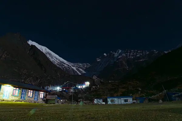 Kyanjin Gompa, Langtang, Nepal - 16 Ekim 2024: Kyanjin Gompa Night View with Stars over the Langtang Lirung in Himalayas of Nepal and Tea house