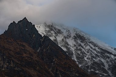 Sabahın erken saatlerinde Nepal Himalayaları 'ndaki langtang lirung dağında bulutlar Tsergo Ri' ye doğru ilerliyor.