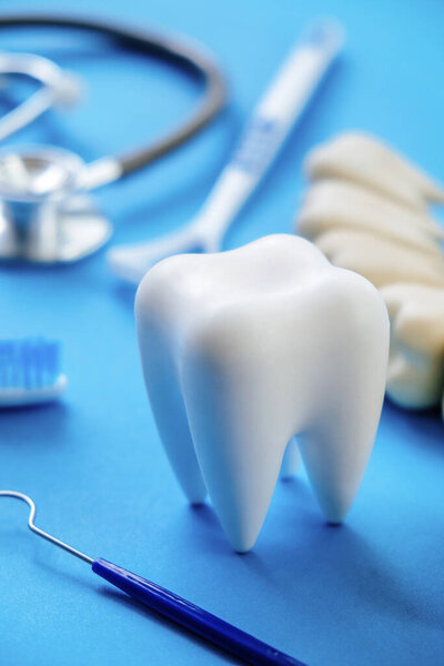 Dental model and dental equipment on blue background, Dentistry concept.