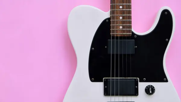 粉红背景上的黑白电吉他 顶部视图 — 图库照片