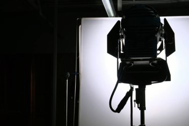 Silhouette of a professional studio lighting equipment on the stage. clipart