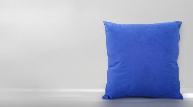 Blue pillow on against room background wall