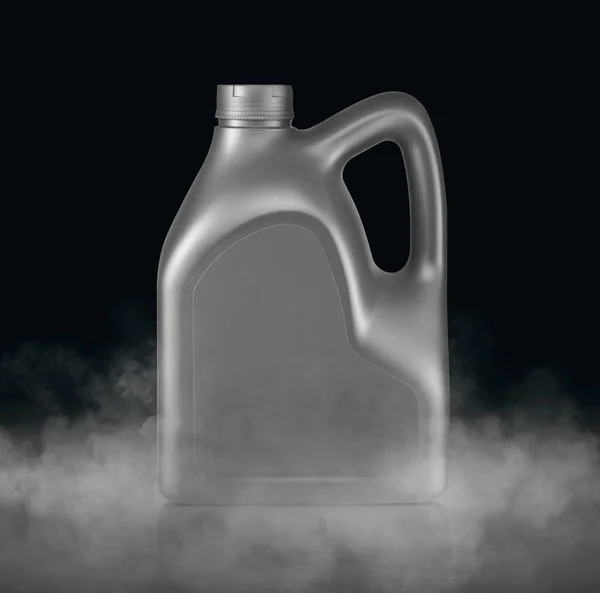 Plastic canister for machine oil with cold vapor an isolated dark studio background