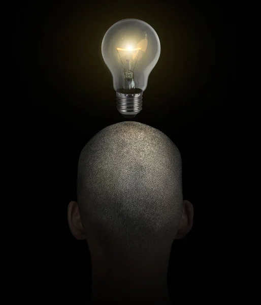 The idea of a man with a glowing light bulb in the middle