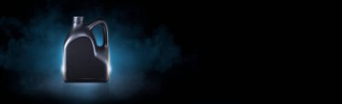 Black bottle of engine oil on black background with smoke