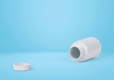 Açık mavi arka planda boş plastik hap şişesi.
