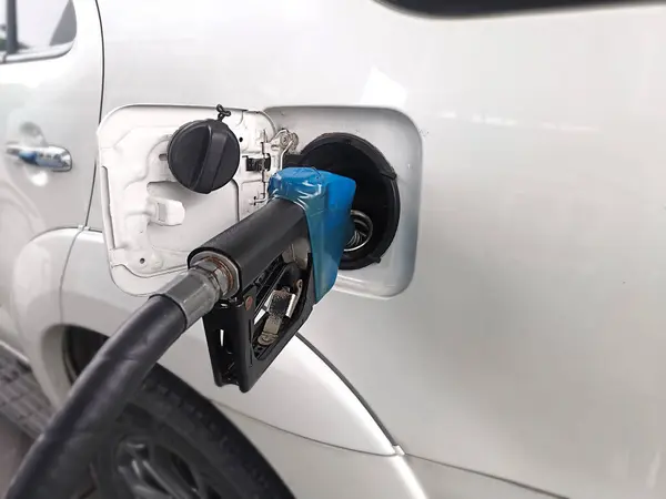 stock image Refueling Car fill with petrol gasoline at gas station and Petrol pump filling fuel nozzle in fuel tank of car