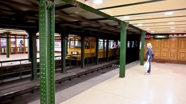 Budapest, Hungary, August 2022. Slow motion footage of Metro 1 : the city's first. Fully functional and preserved in its vintage look. A typical yellow train is arriving at the Oktogon station