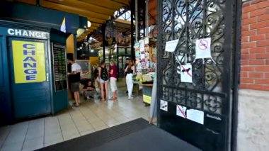 Budapest, Hungary, August 2022. Immersive pov footage entering the Central Market. We go through the entrance, we scroll through the crowds and then walk along the stalls with the goods on display.