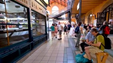 Budapest, Hungary, August 2022. Immersive pov footage in the central market. We scroll among the people and then walk along the stalls with the goods on display.