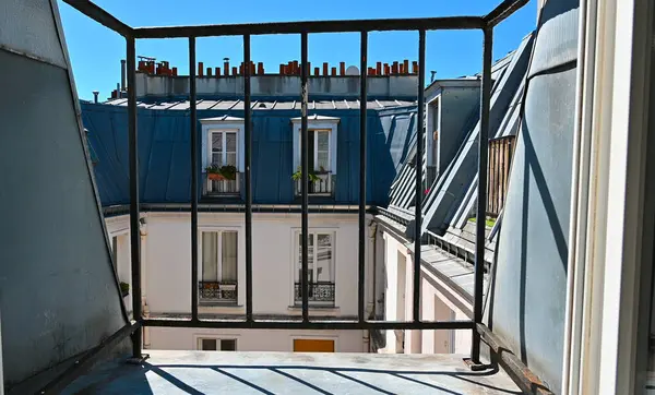 Paris, France. Escape from domestic life: POV shot towards the attic window. Concept of carefree, freedom, lightness and holiday.