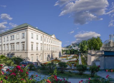 Salzburg, Austria, August 15 2022. Enchanting daytime shot of the Mirabell Palace Gardens. People visit them and explore. The in highlights the Hohensalzburg fort in the background. clipart