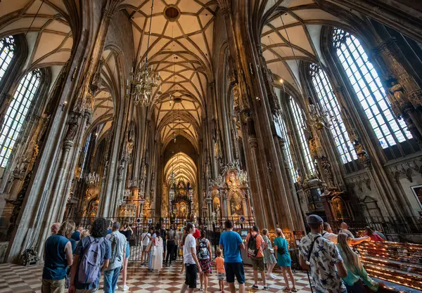 stock image Vienna, Austria, August 17, 2022. Interior of St. Stephen's Cathedral, it is full of people visiting. Natural light enters through the large windows.