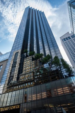 New York, NY, USA. August 17, 2024. Trump Tower in an iconic low-angle POV shot with wide-angle lens. Symbol of power and wealth of the former American president. Vertical format. clipart