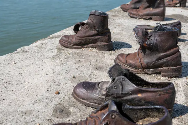 stock image Budapest, Hungary. 25 August 2022. Memorial to the victims of the Nazi repression. Rusty metal copies of old shoes on the Danube River embankment. Holocaust and Nazi terror memory concept.