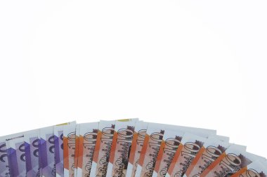 A plan view of spread of ten and twenty pound notes sterling isolated on a white background.