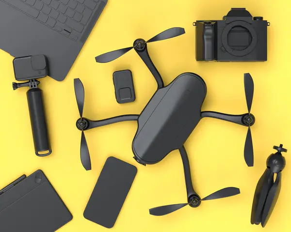 Top view of monochrome designer workspace and gear like laptop, nonexistent DSLR, drone, mobile phone and action camera on yellow background. 3d render of accessories for video and photography tools