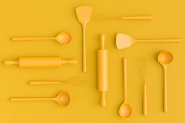 Ahşap mutfak aletleri, aletler ve ekipmanlar sarı monokrom arka planda. Ev yapımı mutfak aletleri ve yemek pişirmek için aksesuarlar