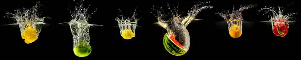 stock image Group of falling fruits and vegetables in water with splash on black background.