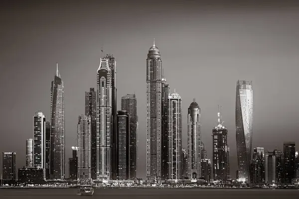 Aydınlatılmış gökdelenleri ve gece siyah beyaz rıhtımlı şehir silüeti, kentsel gelişim konsepti, Dubai Marina Körfezi BAE