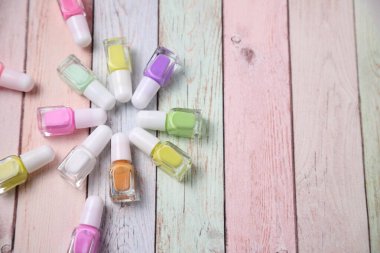 Bunch of nail polish bottles, colors of enamel, copy space