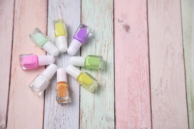 Bunch of nail polish bottles, colors of enamel, copy space