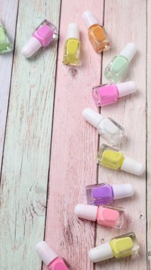 Bunch of nail polish bottles, colors of enamel, copy space