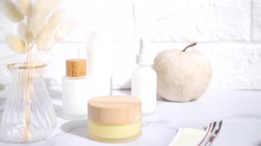 Cosmetic table, woman hand is taking a bottle, lifestyle staging