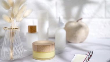 Cosmetic bottles on table, shadows, lifestyle staging 