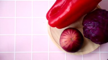 Raw fresh vegetables on wooden plate 